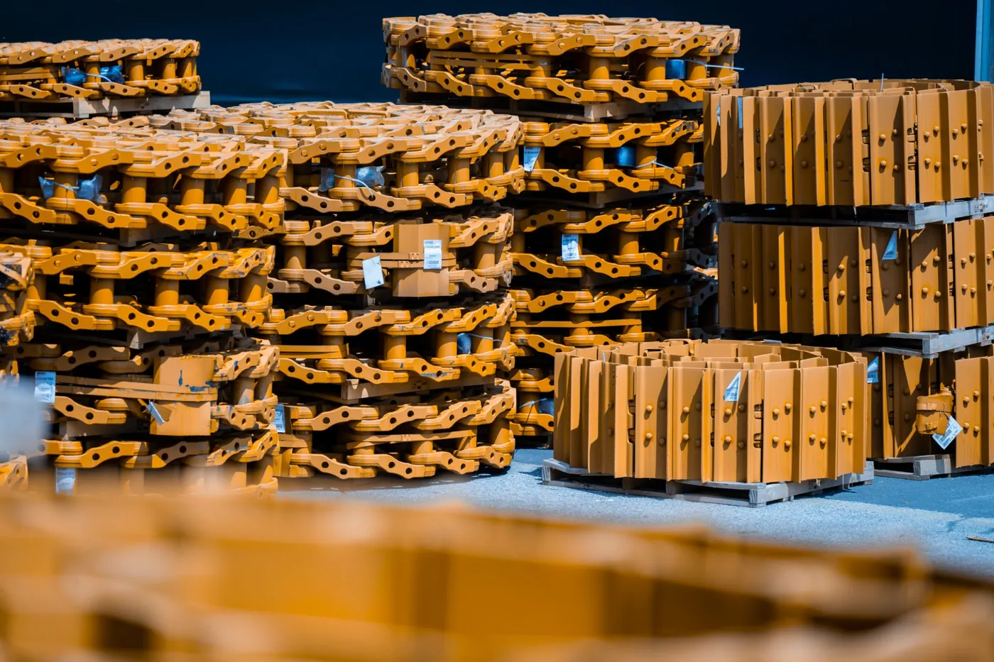 Berco track chains and track shoes stacked on pallets, ready for shipment