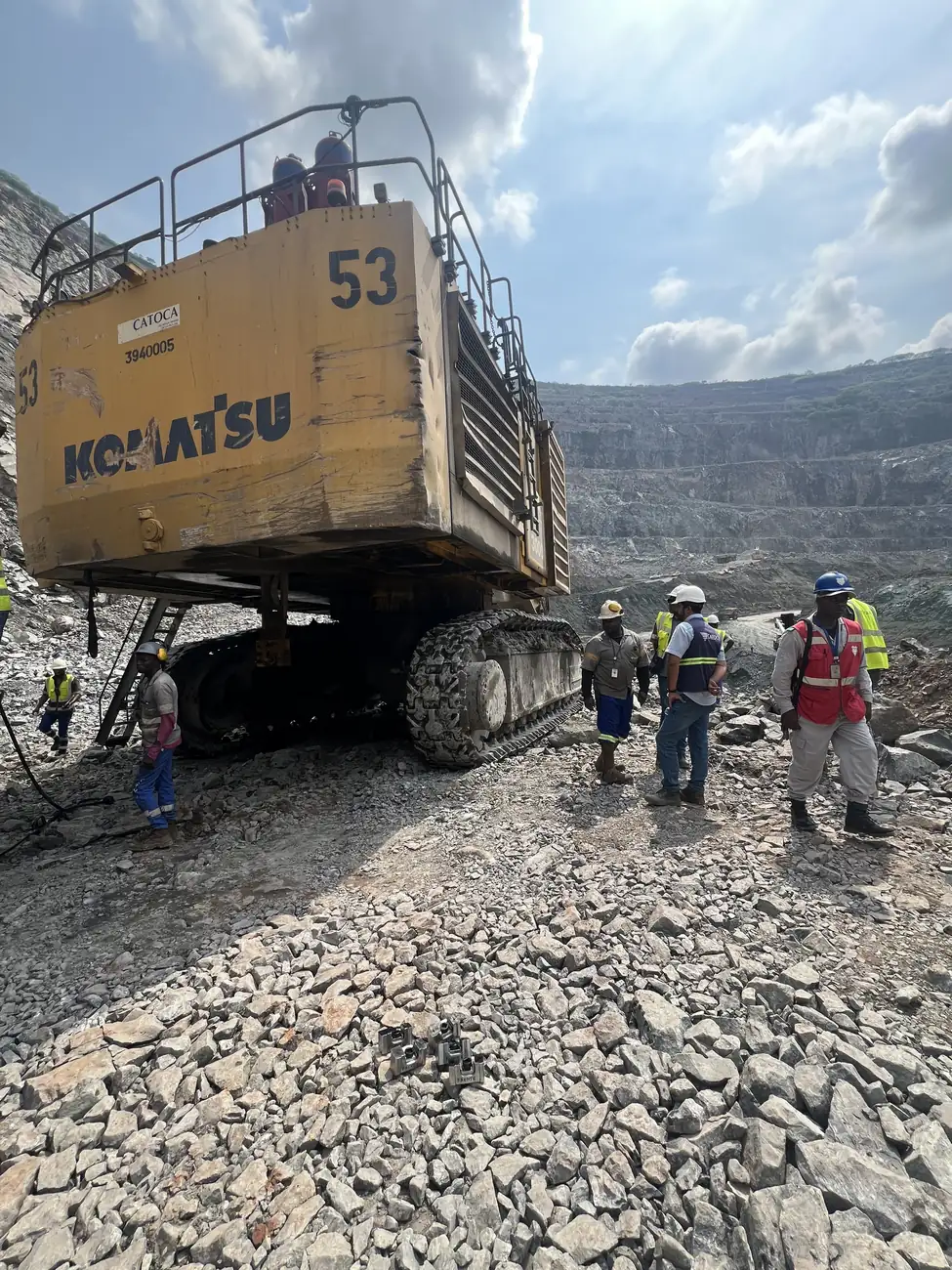 Crew at the foot of a Komatsu haul truck